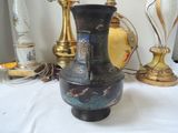a vase that is sitting on a table next to a lamp