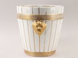 a white and gold vase with a gold decoration on it