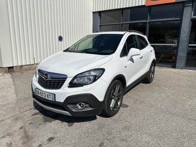 a white car parked in front of a building