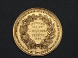 an image of a gold coin with a wreath on it