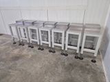 several stools are lined up against a wall in a room