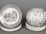 two black and white plates with a picture of a man and a woman on them