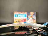 a toy airplane that is sitting next to a box of plastic toys