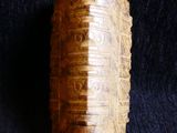 a close up of a wooden object on a black surface