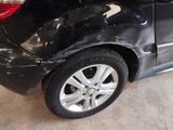 a picture of a car that has been dented and is in a garage