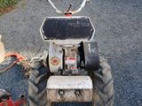 a small tractor that is parked on the side of the road
