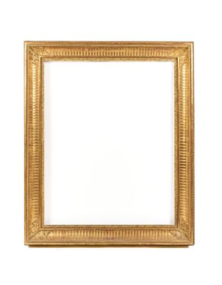 a gold picture frame on a white wall with a white background