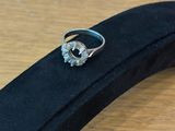 an image of a diamond ring sitting on top of a black case