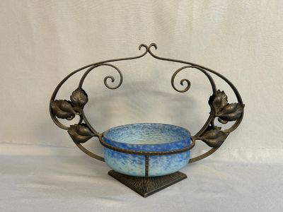 a blue bowl sitting on top of a metal stand