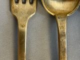 two spoons and a fork sitting on a table