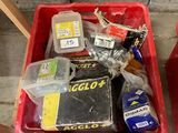 a red container filled with assorted items sitting on the floor