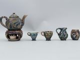 several pieces of pottery are arranged in a row on a white surface