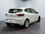 the rear end of a white car in a white room