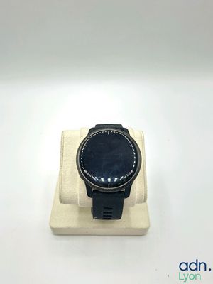 a smart watch sitting on a stand on a white surface