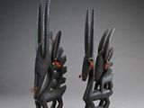 pair of african carved wooden sculptures of a bird and a snake