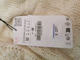 a white tag that is attached to a cell phone