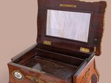 a small wooden box with a mirror on top of it