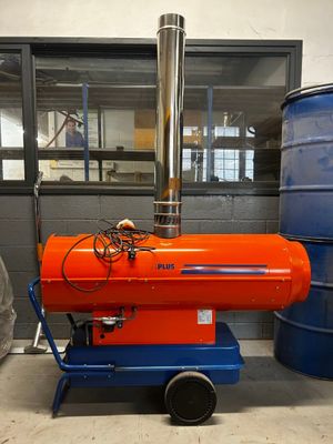 an orange proprigerator sitting on a cart in a room