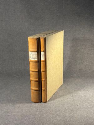an old book sitting on top of a table next to a gray background