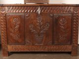 a wooden chest with a plant on top of it