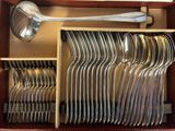 a lot of spoons and forks in a box