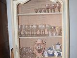 a china cabinet that has a lot of glass in it