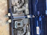 two tools in a blue case sitting on the floor