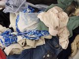 a pile of clothes that is sitting in a basket