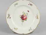an image of a plate with flowers on it sitting on a table