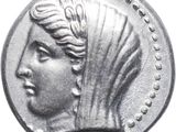 a close up of a silver coin with a woman ' s head on it