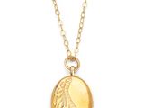 a gold locke necklace with a paisley design on it