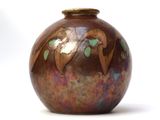 a brown vase with a bird design on it