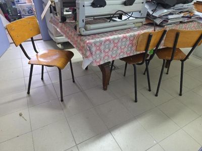 a table with a bunch of chairs and a computer on it