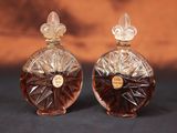 deux flacons de parfum posés l'un à côté de l'autre sur une table