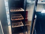 des bouteilles de vin sont conservées dans une cave à vin installée dans une cuisine