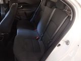 the back seats of a white car with a black seat belt