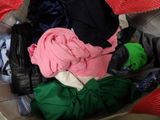 a suitcase full of clothes that is sitting on the floor