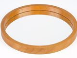 a round mirror with a wooden frame on a white surface