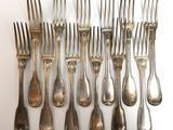 a lot of forks and spoons on the table