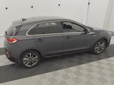 the back end of a gray car parked in a garage