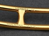 a close up of a gold belt buckle on a black surface