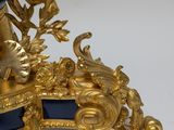 a black and gold clock sitting on top of a table