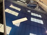 a reflection of a boat on the windshield of a car