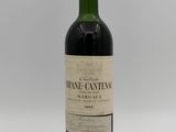 a close up of a bottle of wine on a white surface