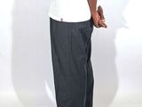 a man in a white shirt and black pants posing for a picture