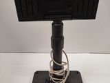 a close up of a monitor on a stand on a white surface