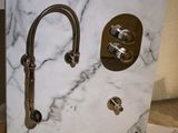 a white marble counter top with a faucet and a faucet