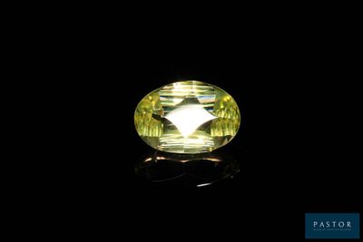 a yellow sapphire stone on a black background