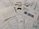 the label on a white shirt is attached to a tag