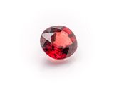 a red garnet stone on a white background
